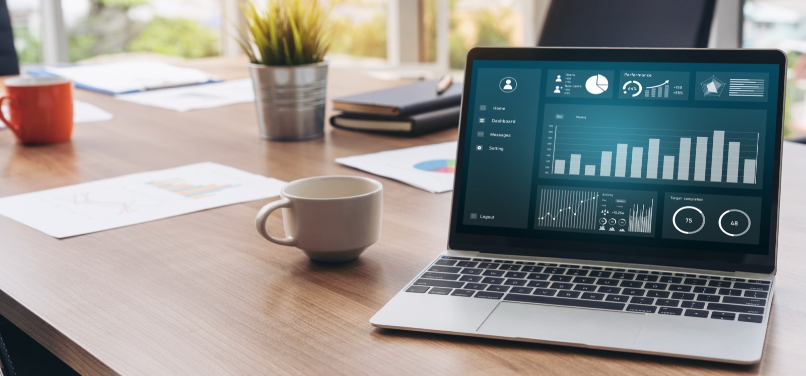 Laptop on a table showing a website analytics dashboard.