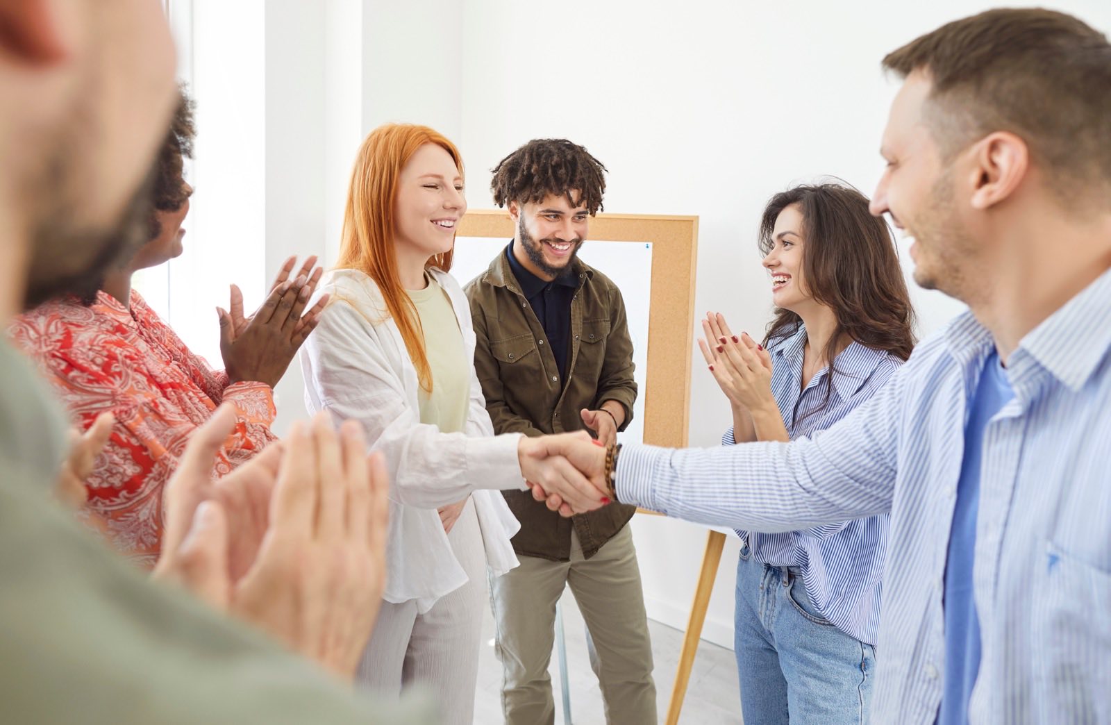 Group welcoming a newcomer to an event.