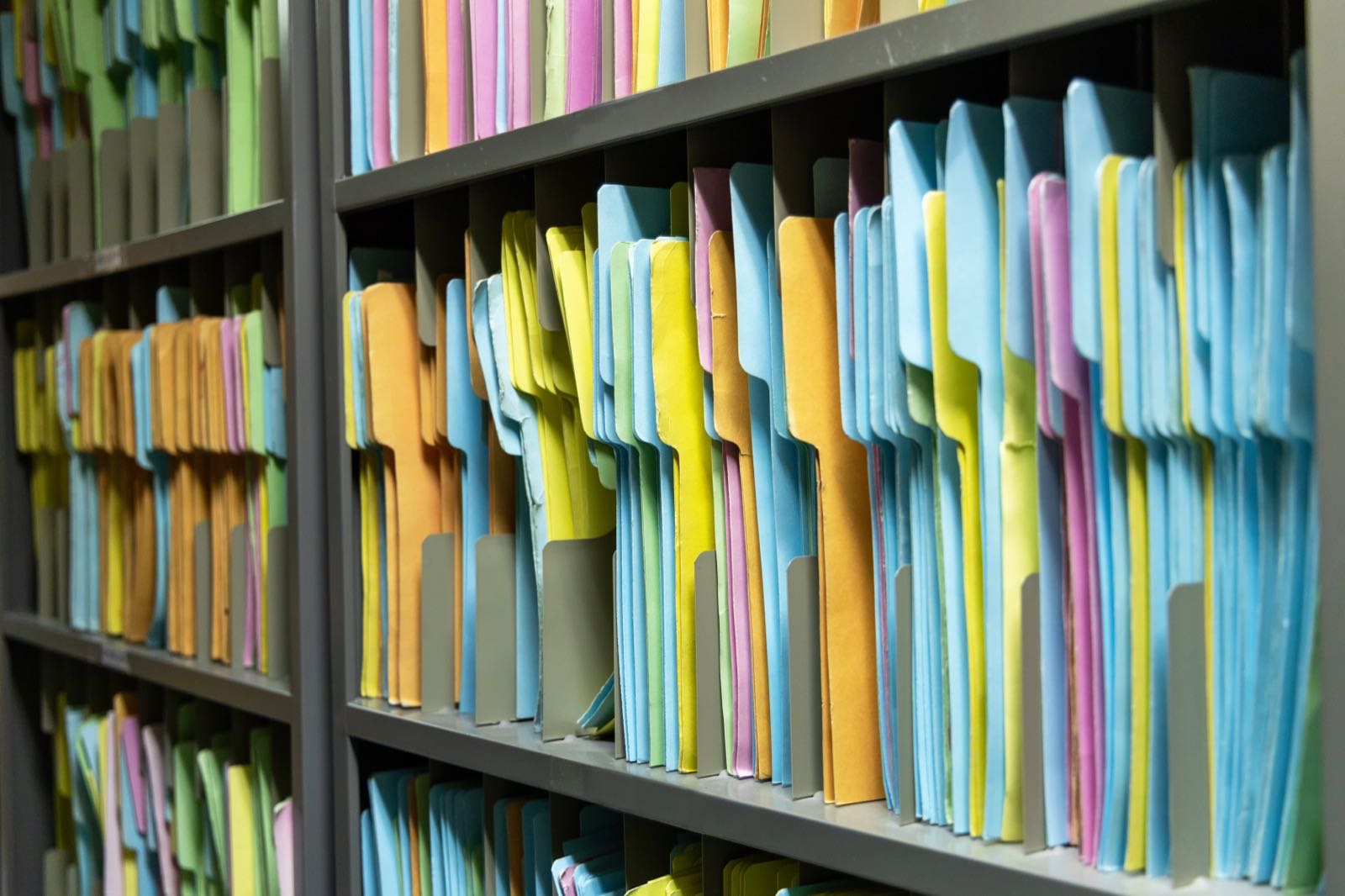 Shelves of colored file folders, neatly organized.