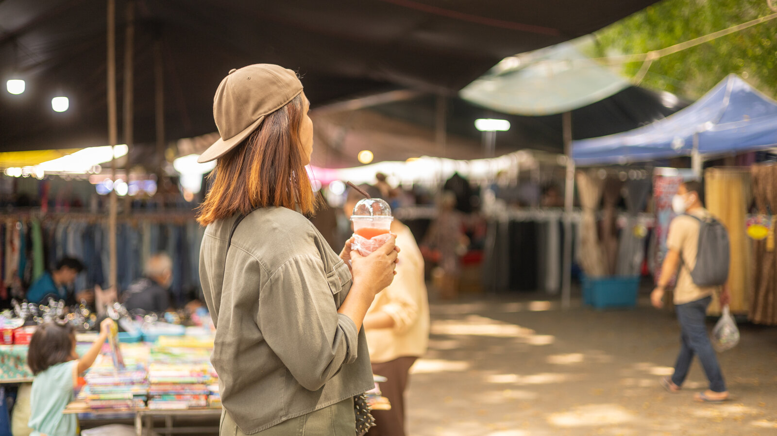 A busy outdoor market full of vendor stalls and visitors, the kind of public event where a club can show up and be part of the community.